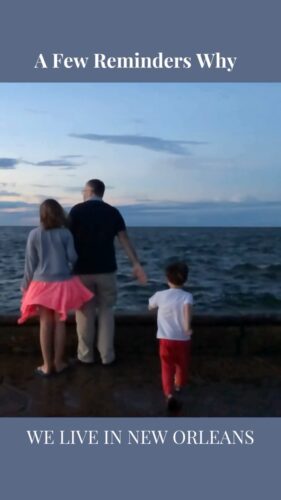 a man and two children standing by the water