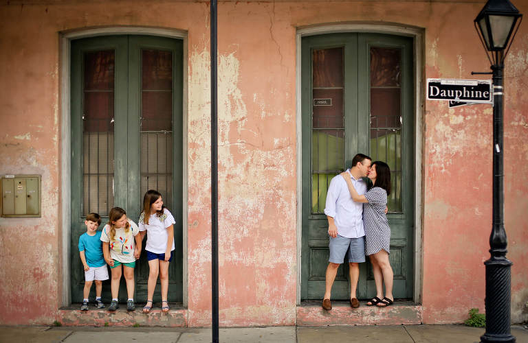 Family posing for Fall photos in the French Quarter.