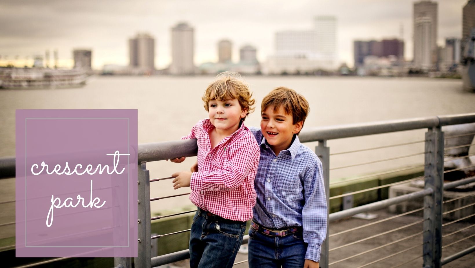 Two brothers standing along the Mississippi River for photos in New Orleans. 