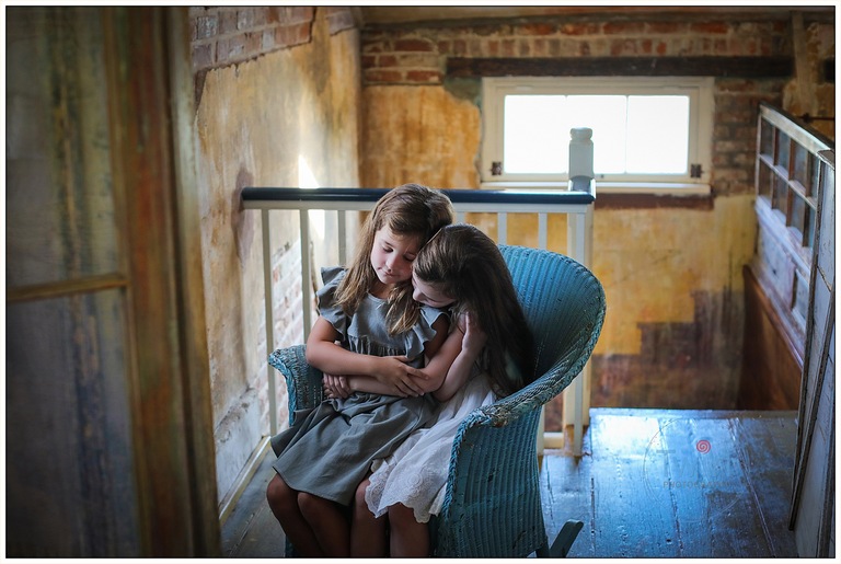 Two young girls pose for portraits at Race and Religious, a historic home in New Orleans.