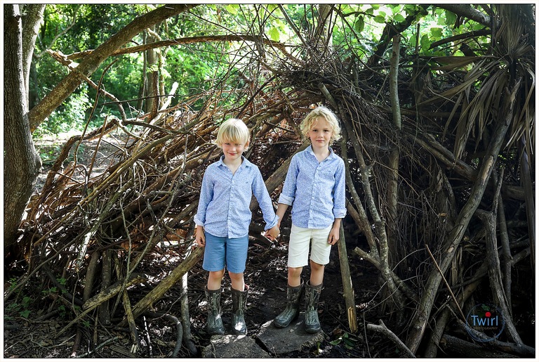 Two brother standing in front of a twig fort at Couturie Forest in New Orleans for photos.