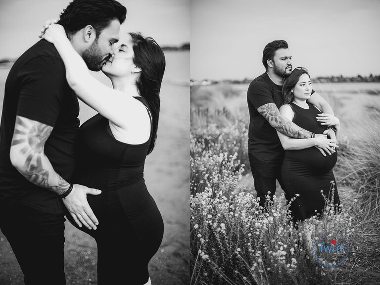 Couple in a field hugging and showing a pregnant belly during maternity photos.