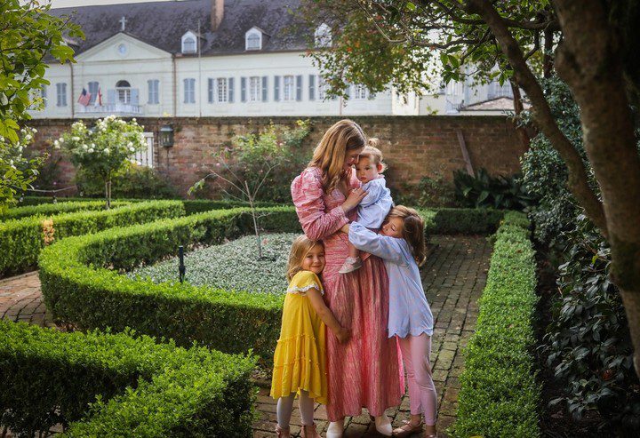 Mother and here 3 children in the French Quarter garden photographed by Twirl Photography. Romantic date night ideas in New Orleans. 