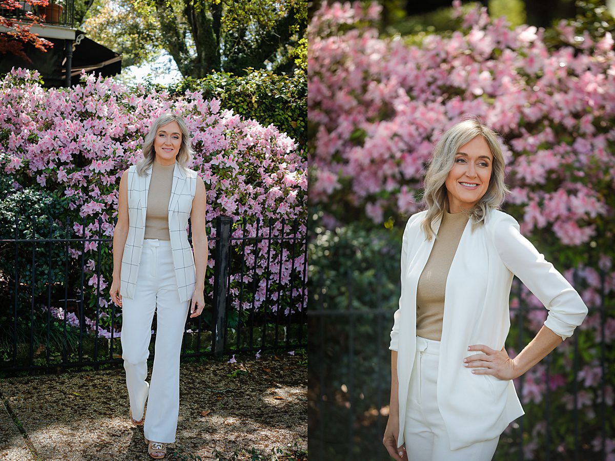 A woman in a white suit posing for headshots in front of a blooming Azalea bush in New Orleans illustrating effortless ways to feel comfortable in front of a camera for headshot photos.