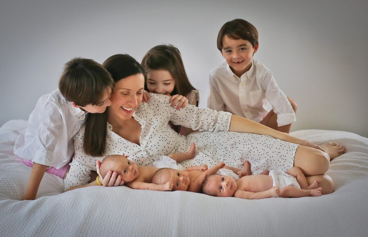 Mom with her six kids, two sets of triplets. Including 3 1-month-old babies all together for a photo by New Orleans photographer Twirl Photography.