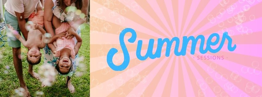 Two kids in bathing suits laughing and playing with their parents in a backyard sprinkler during a photos session for the best location for summer family photos in New Orleans.