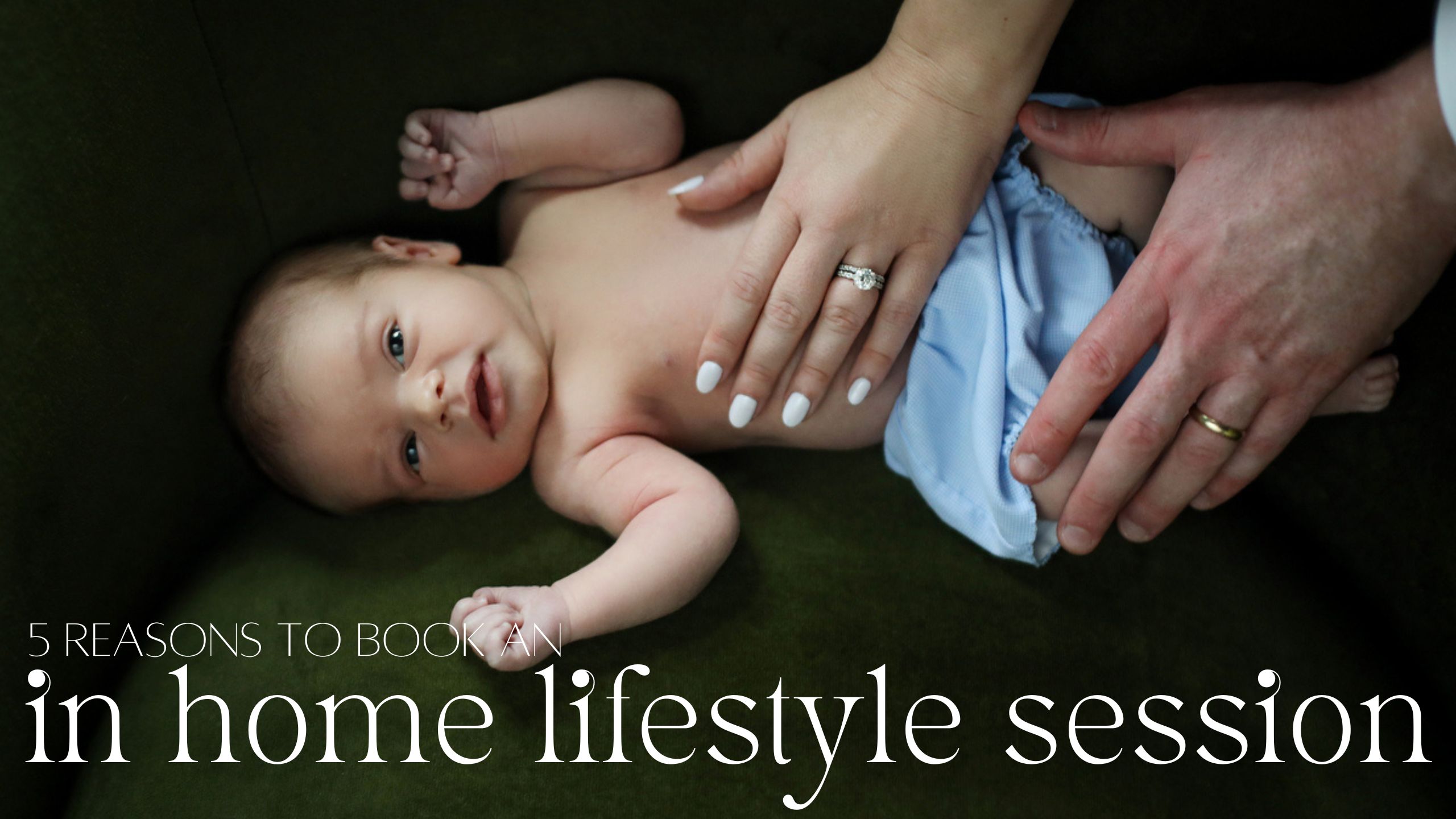 A newborn baby looking at the camera with mom and dad's hands on it's belly during an in home New Orleans lifestyle session with Twirl Photography.