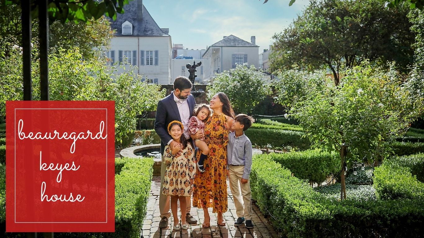 A family smiling at each other in a private French Quarter courtyard during a New Orleans mini session.