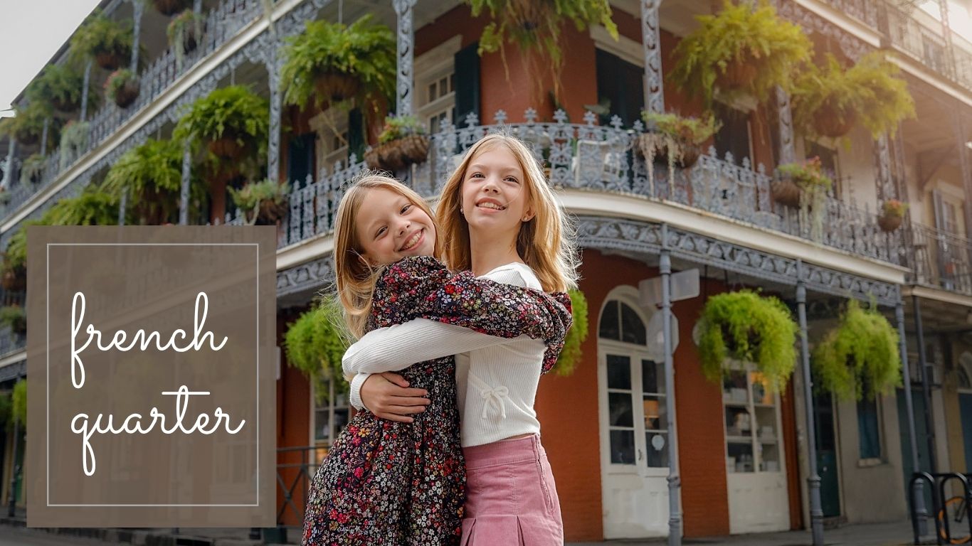 Two sisters hugging in the French Quarter during a mini session in New Orleans.