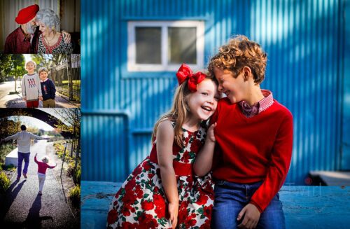 A sister and brother hugging in front of a blue building. They are both wearing the color red.