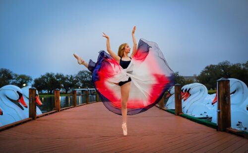 a woman dancing on a dock