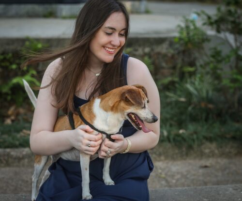 a woman holding a dog