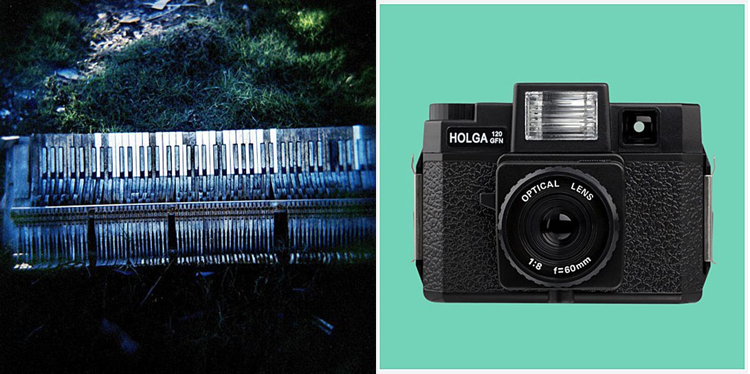 A picture of a piano keyboard on the ground and a Holga camera.