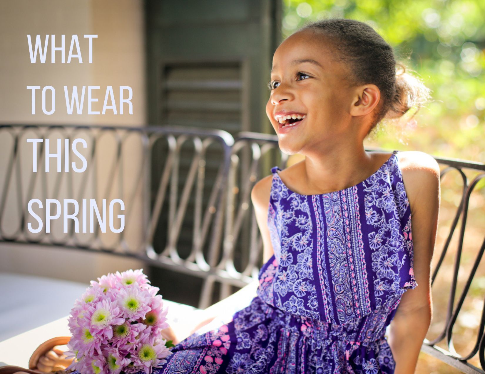 A little girl wearing a bright purple dress with flowers posing for a photo about what to wear for spring photos in New Orleans.