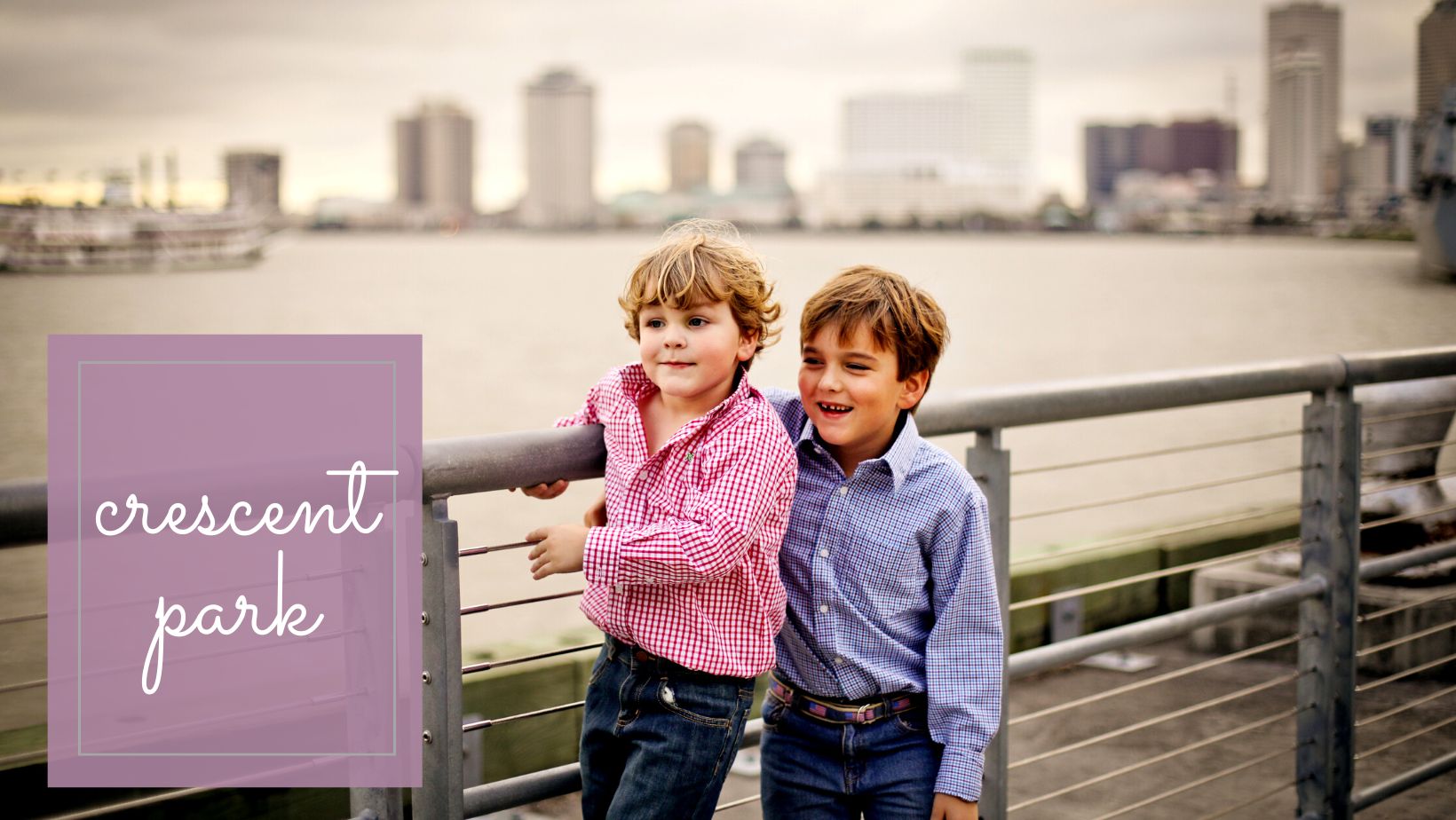 Two boys standing in front of the New Orleans skyline.