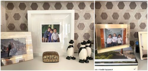 Several small framed prints on a bookshelf.
