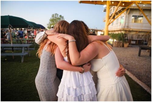 several high school seniors hugging at the batter in New Orleans.