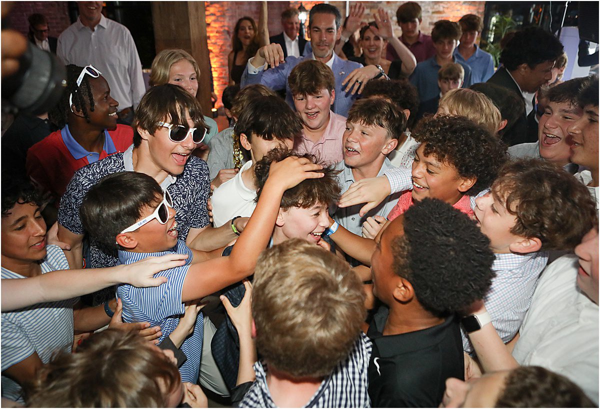 several boys congratulating the guest of honor during a bar mitzvah.