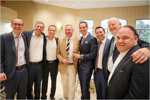 several men who grew up friends pose for a picture at a luncheon.