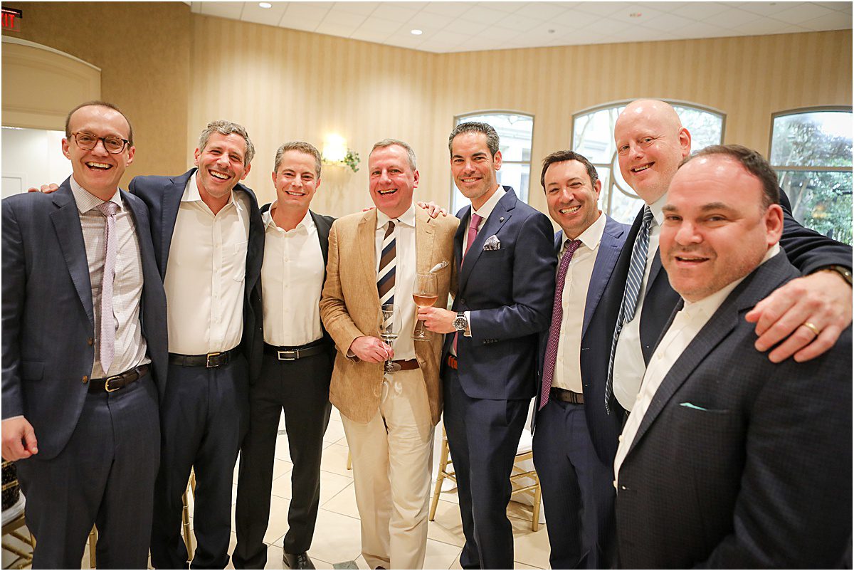 several men who grew up friends pose for a picture at a luncheon.