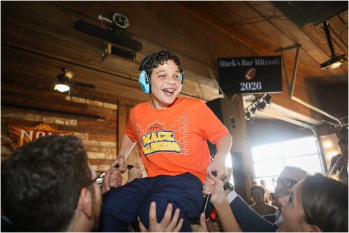 A 13-year-old being lifted on a chair during the Hora at his Bar Mitzvah.