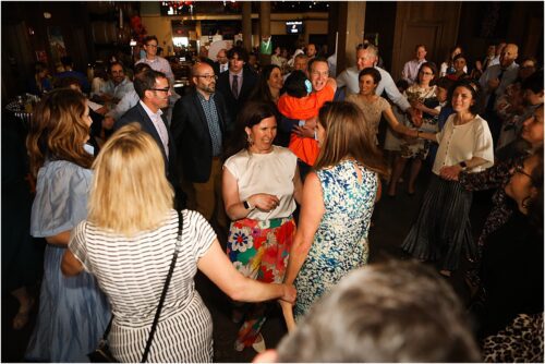 Family and friends dance in a circle during a bar mitzvah.