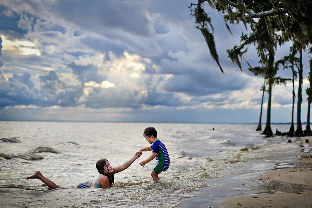 Two kids in the water at fourntainbleu state park.