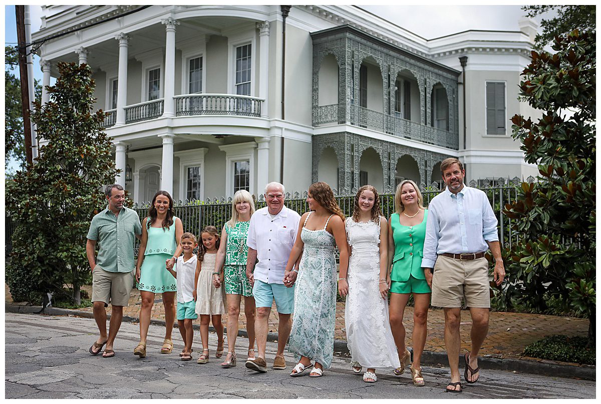 A large family walking across the street in the Garden District of New Orleans.